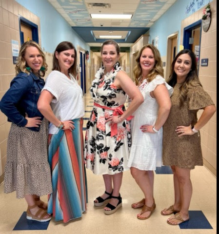 Third grade teachers pose in the hallway